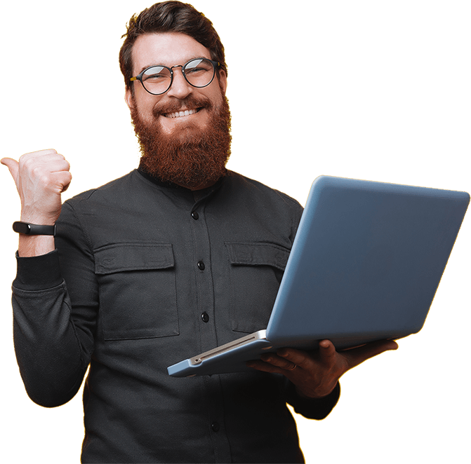 Bearded man smiling in a dark shirt, while holding a laptop