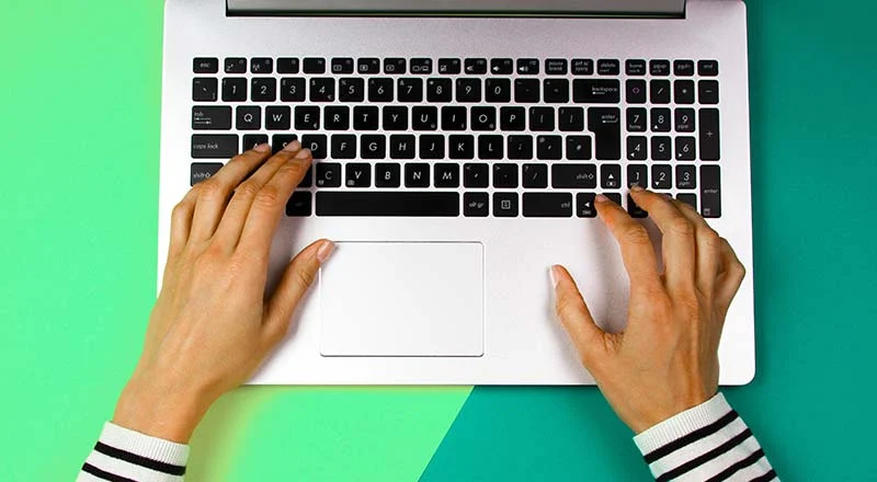 Typing on a laptop