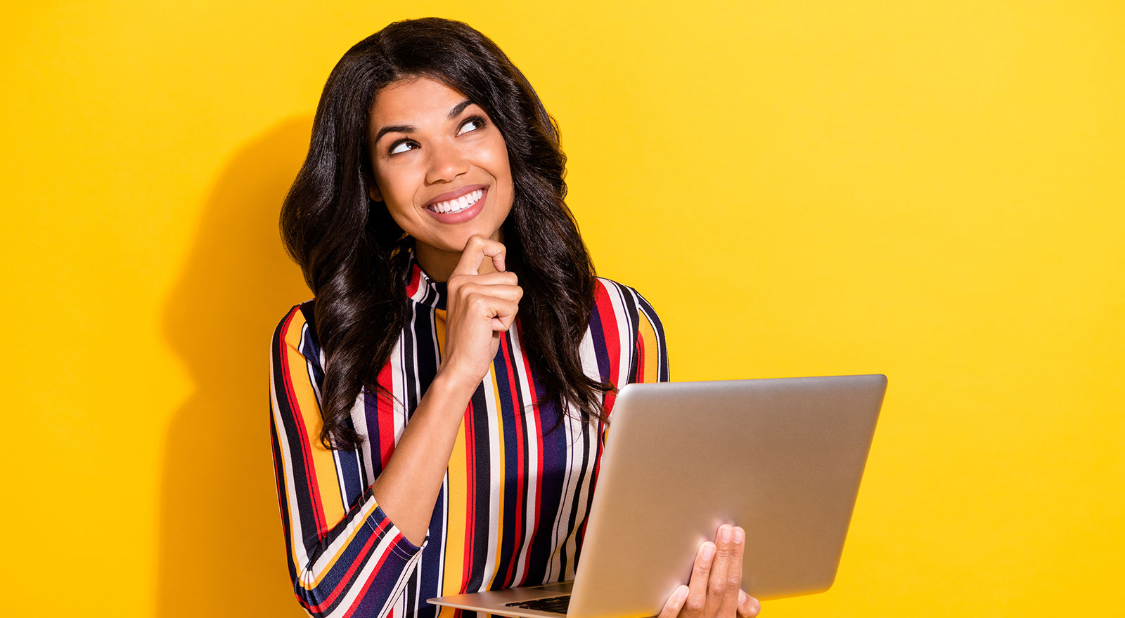 Woman on computer considers how to write an insurance ad