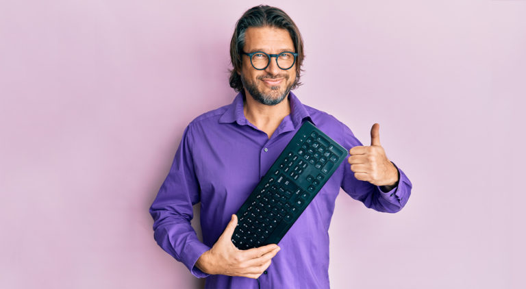 A man poses with keyboard.