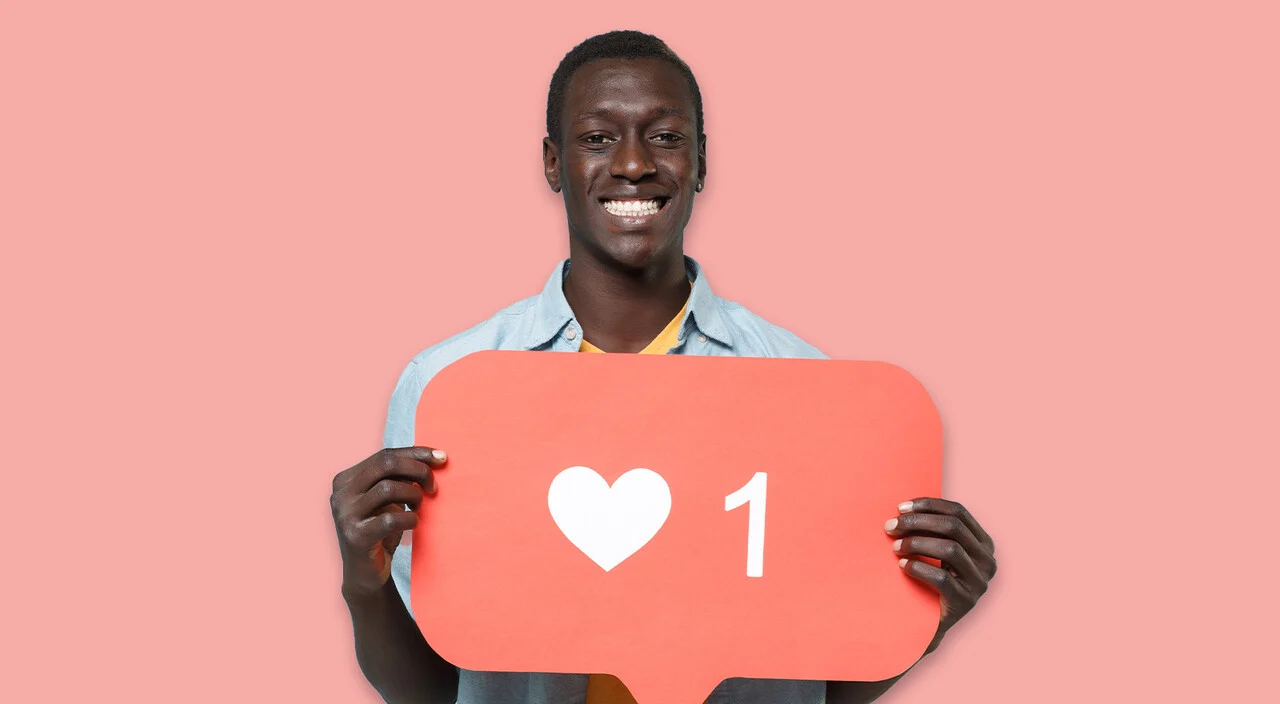 Man holding Instagram heart icon.